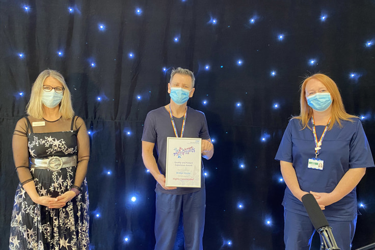 Bridge House team members with award