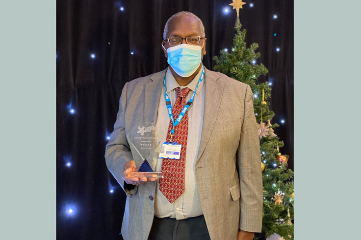 Ralph Craig with award