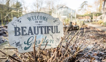 Sign that reads 'Welcome to my beautiful garden'