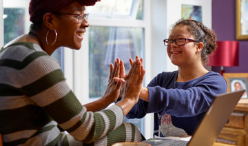 Mother and daughter clapping hands together