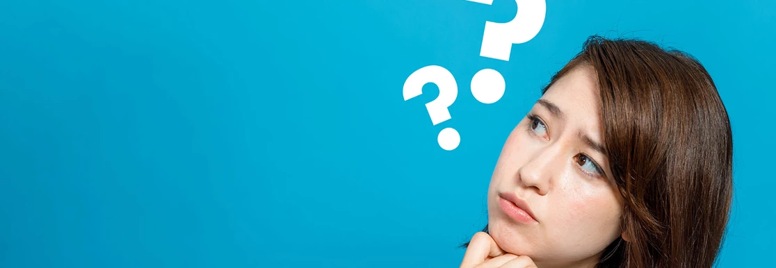 Lady looking confused with question marks around her head
