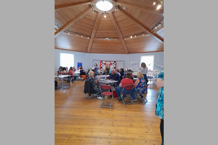 Members of the Forget me Nots gathered and talking at event