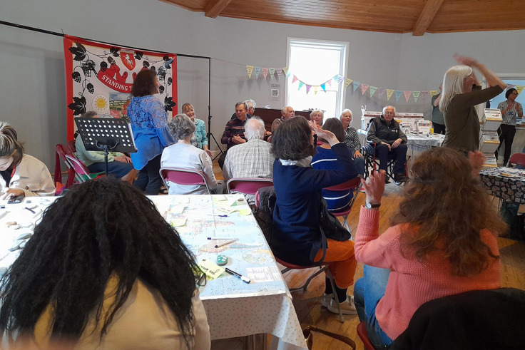 Members of the Forget me Nots gathered and talking at event