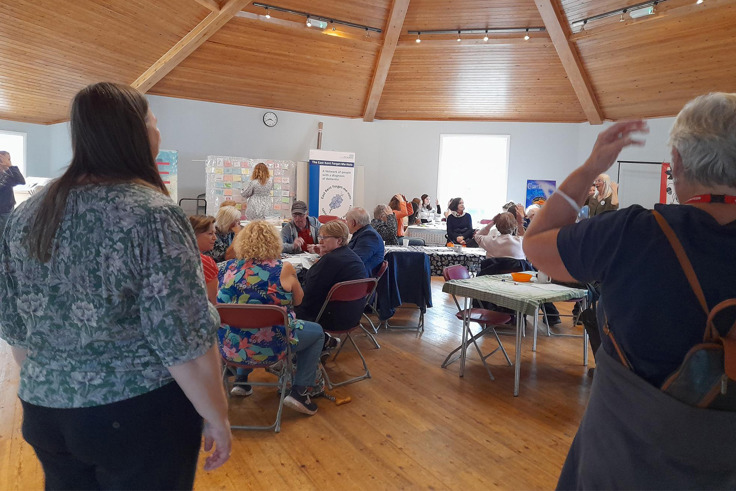Members of the Forget me Nots gathered and talking at event