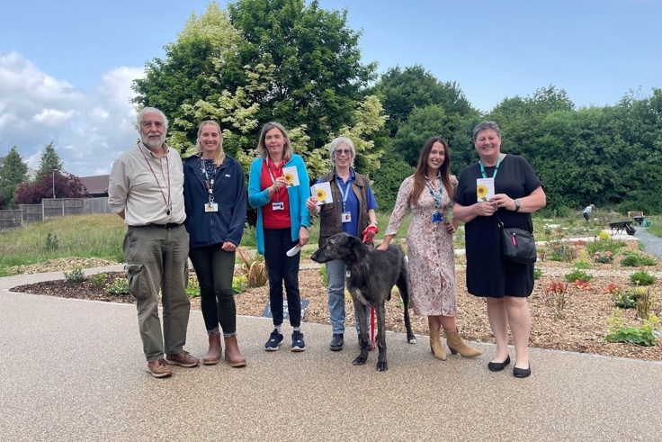 Volunteers in the garden with a dog